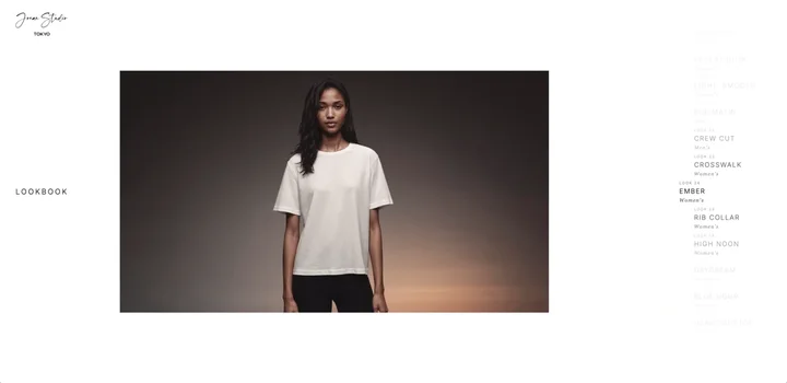Look 24 “Ember” — white tee against a dark, warm-lit backdrop, at rest