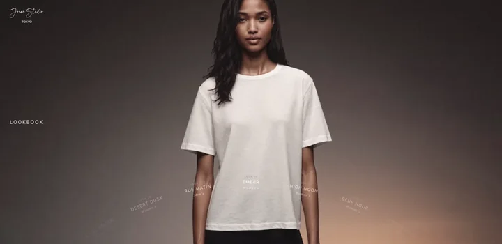 Look 10 “Ember” — white tee against a dark, warm-lit backdrop, the look dial along the bottom