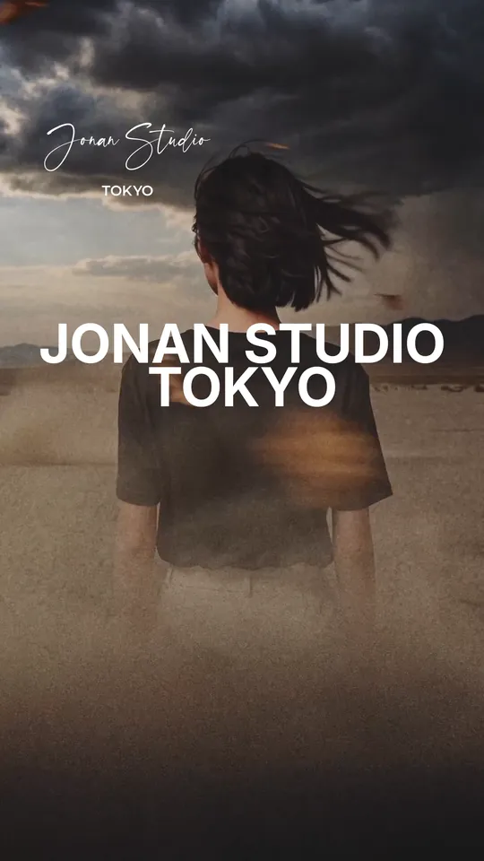 A model walking away under a stormy sky — “JONAN STUDIO TOKYO”