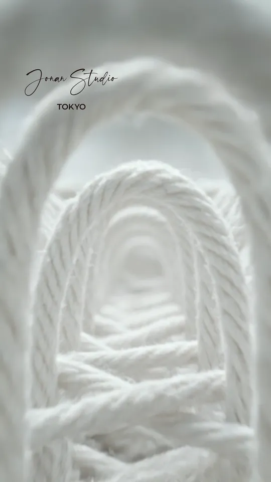 Macro shot of thick white cord with the Jonan Studio logo