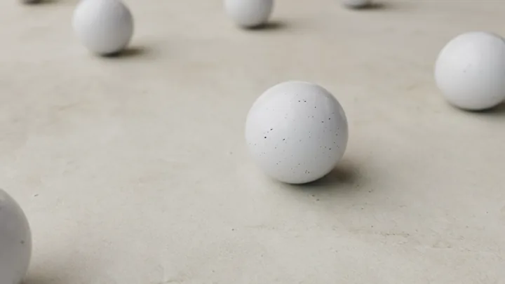White spheres resting on a concrete floor