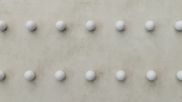 Rows of white spheres lined up on concrete
