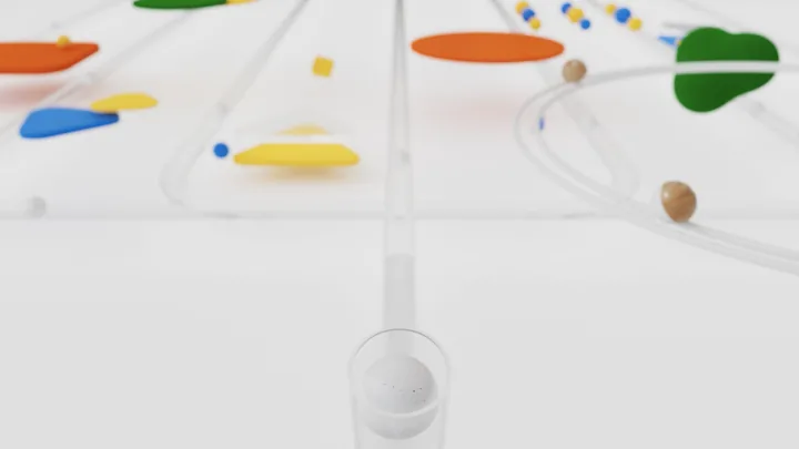 Spheres travelling through clear tubes among coloured shapes