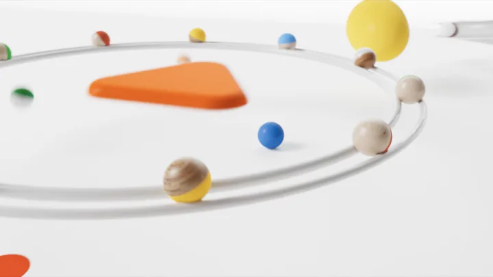 Spheres circling an orange triangle on looping tracks