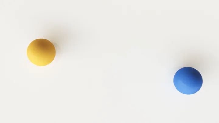 A yellow and a blue sphere apart on white