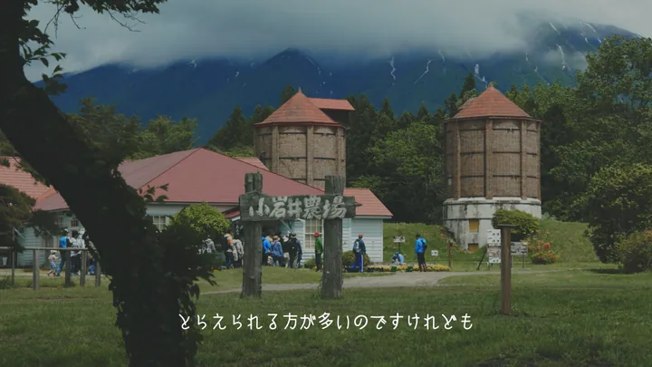 The farm's brick silos and red-roofed barns with visitors