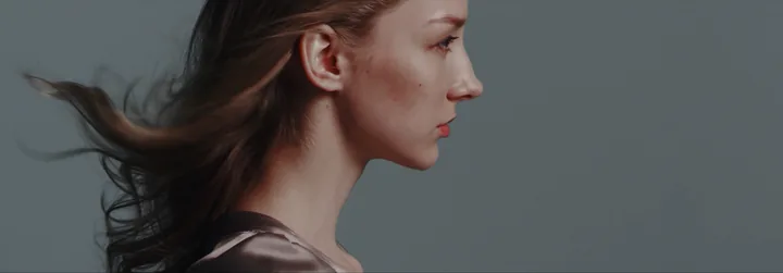 Her profile, hair blowing in the wind