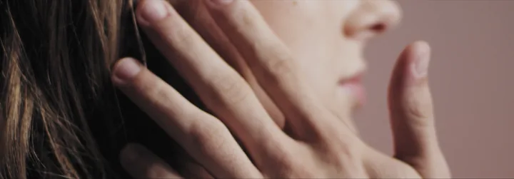 A man's hand on a woman's cheek