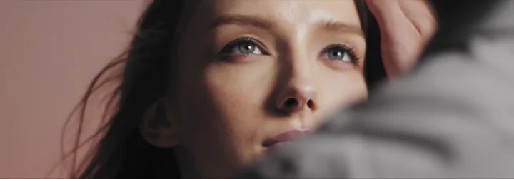 The woman looking up past a man's shoulder