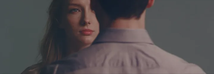 The woman watching over a man's shoulder