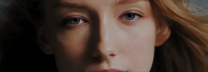 Her face in close-up, eyes on the camera