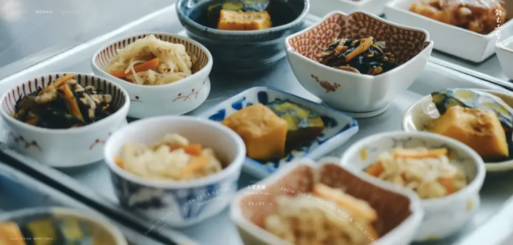 鈴木工藝社 website — ふ定食屋 full screen, small dishes on a tray, the works dial along the bottom