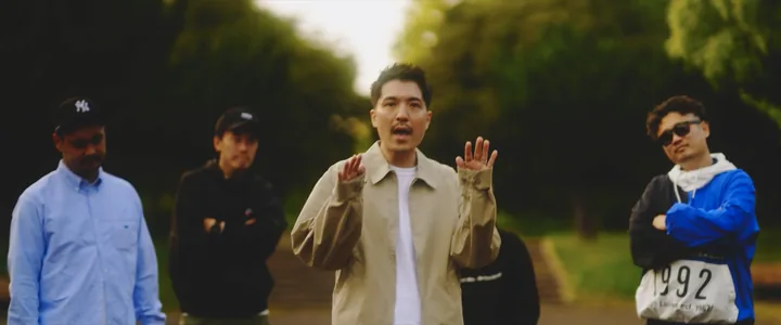 The lead rapping, the crew behind him