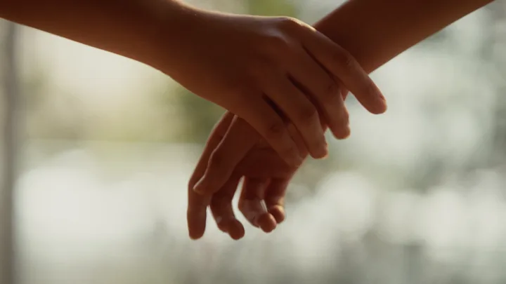 Two hands reaching for each other