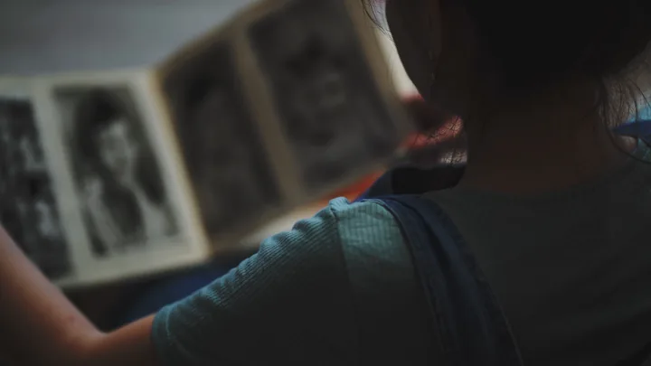 A child turning the pages of an old photo album