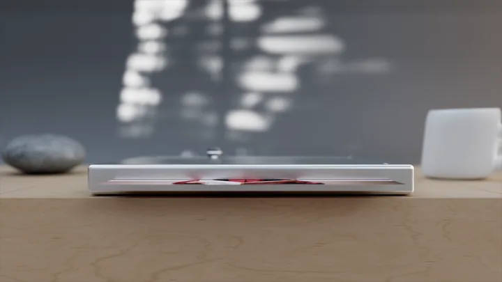 A slim printer on a wooden desk in window light