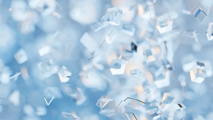 Glass-like fragments floating in blue light