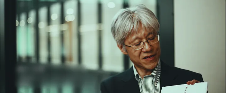 An interviewee holding a printed document