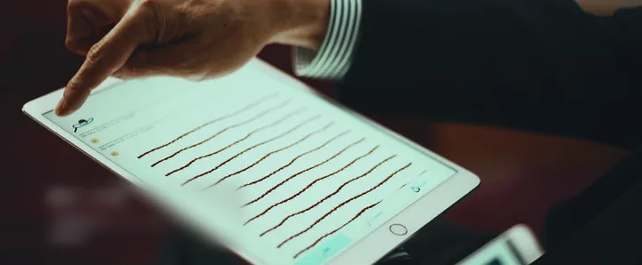 A finger tracing lines on a tablet