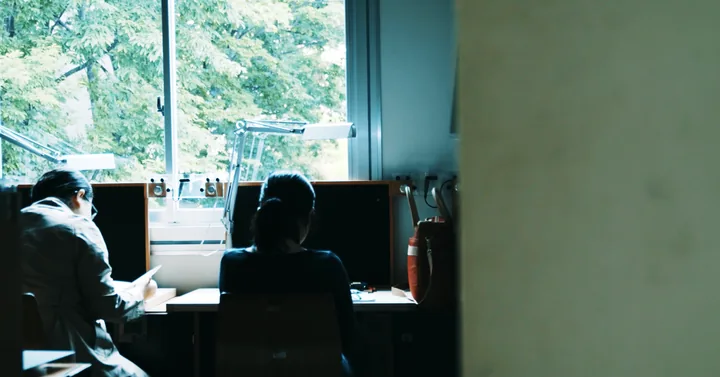 Students at computers in a sunlit room