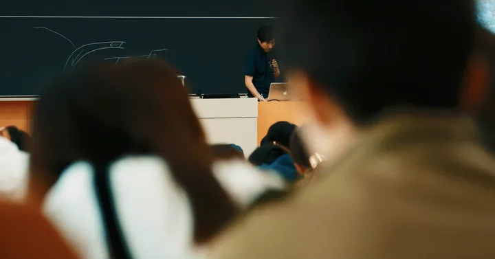 Students in a lecture, seen over their shoulders