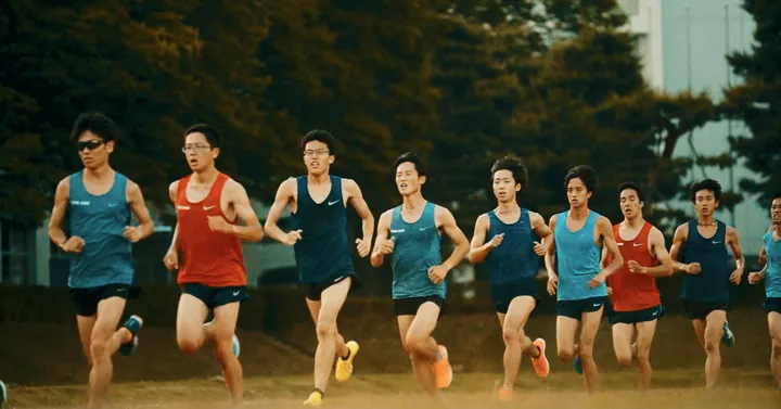 A pack of distance runners on a wooded track
